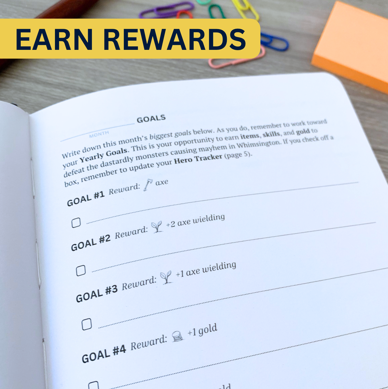 Open planner page with a section for writing monthly goals, each offering rewards like items and skills. The label reads, Earn Rewards.